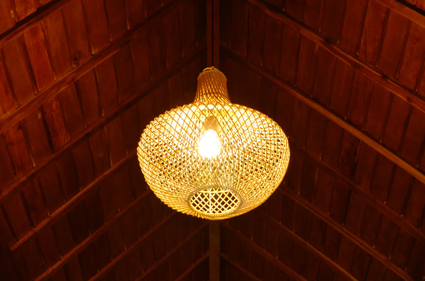 Artisan rattan lamp and teak ceiling